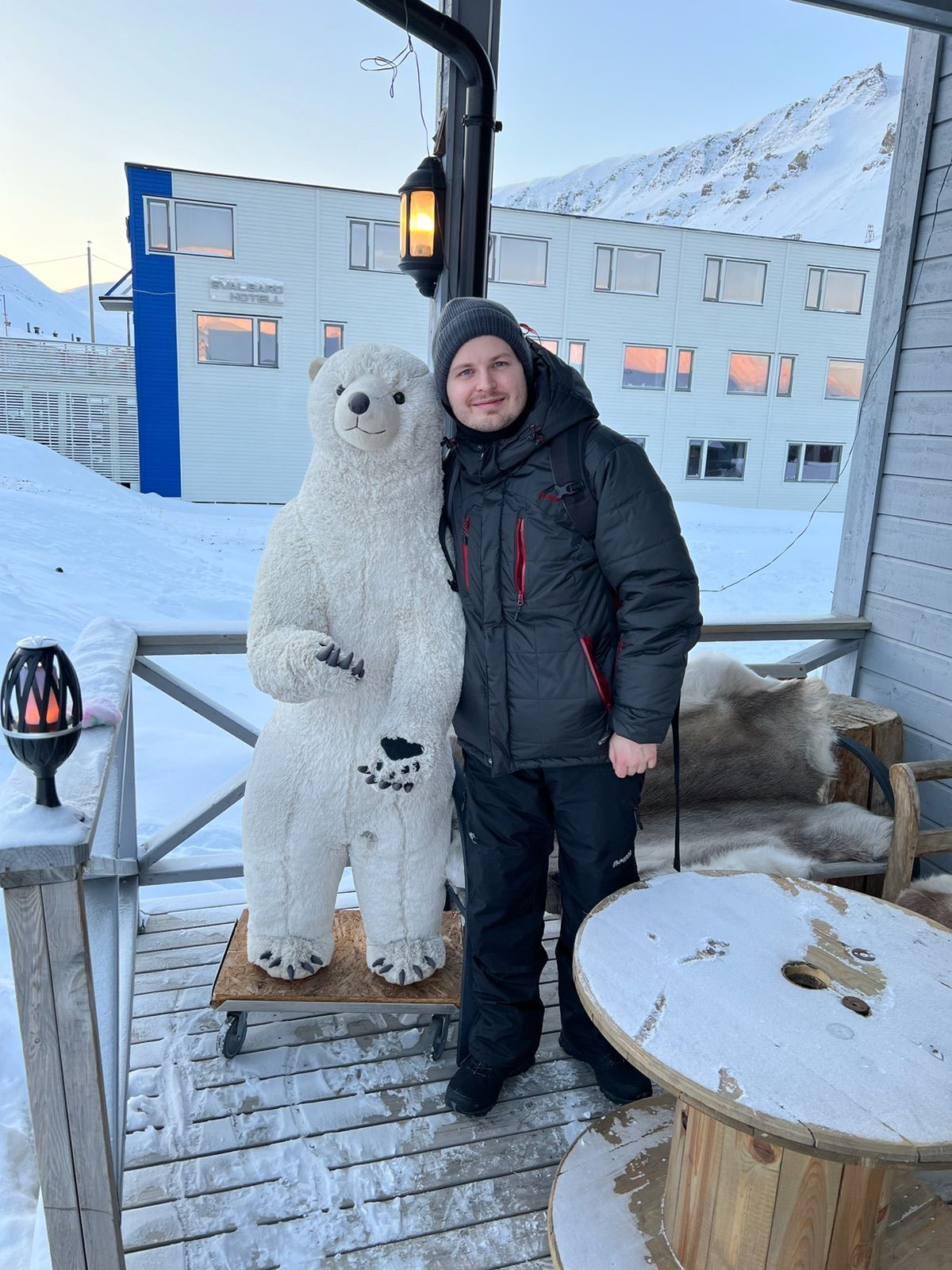 Vegard in winter clothing beside a polar bear figure.